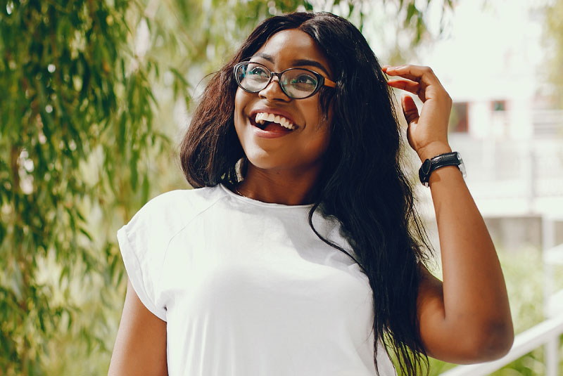 person smiling outside after orthodontic treatment